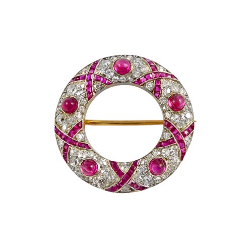 Early 20th century cabochon ruby and diamond stylised wreath brooch, c.1910, with calibre ruby ribbon design,